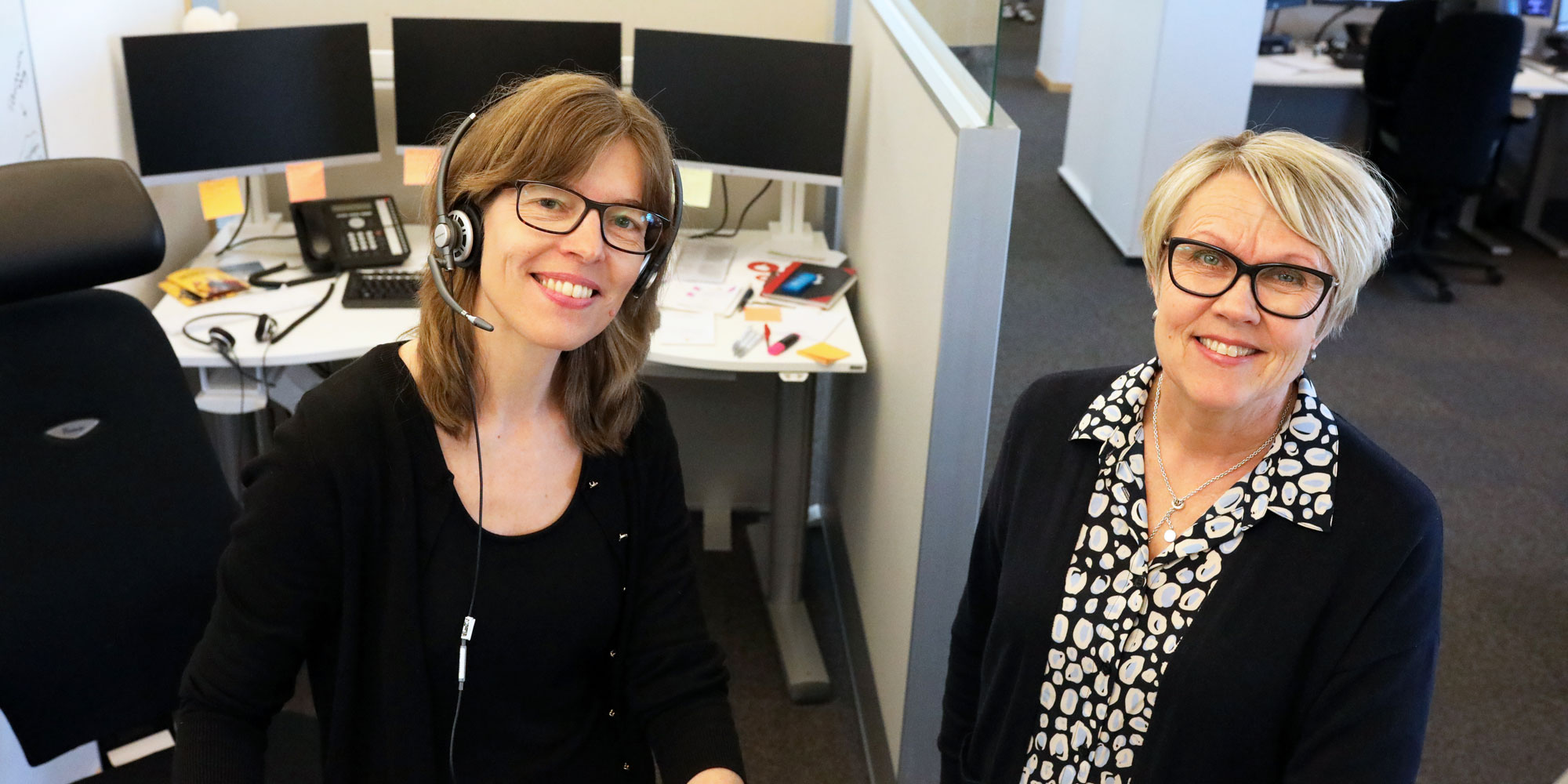 Anna Jernberg, medarbetare, och Ann-Charlotte Andersson, chef, på Kontaktcenter i karlstad, sitter tillsammans vid ett arbetsbord.