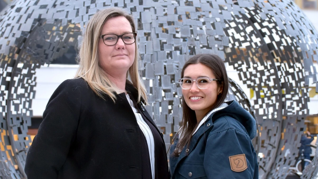 Susanne Hedlöf och Yvonne Åkerlind utomhus framför rund staty, organisatorisk och social arbetsmiljö