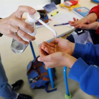 Barnhänder får handsprit ur pumpflaska, åtgärd vid riskbedömning.